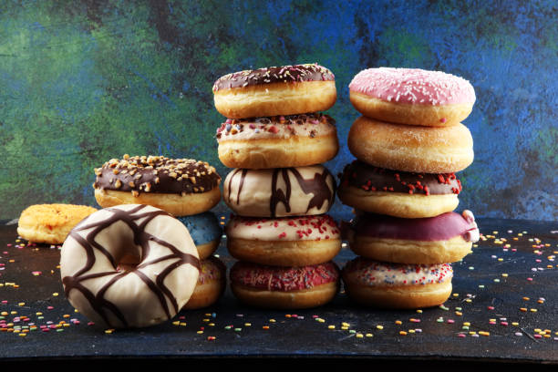 istock assorted donuts with chocolate frosted, pink glazed and sprinkles donuts 1198287232