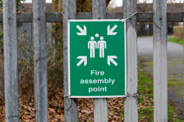 istock Green sign fire assembly point arrows 1198288226