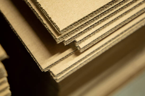 istock Tall stack of recycled material made into cardboard boxes laying flat in a home improvement store for sale 1198288227