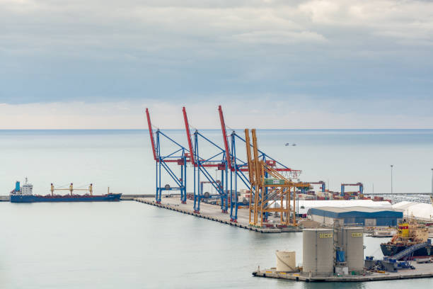 Malaga, Spain; 12/20/2019: View of the port of Malaga, Spain with a container ship on the pier and several cranes