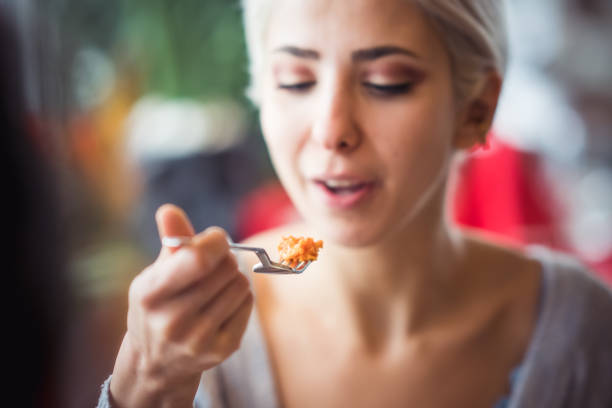 istock Young Woman eating 1198290884