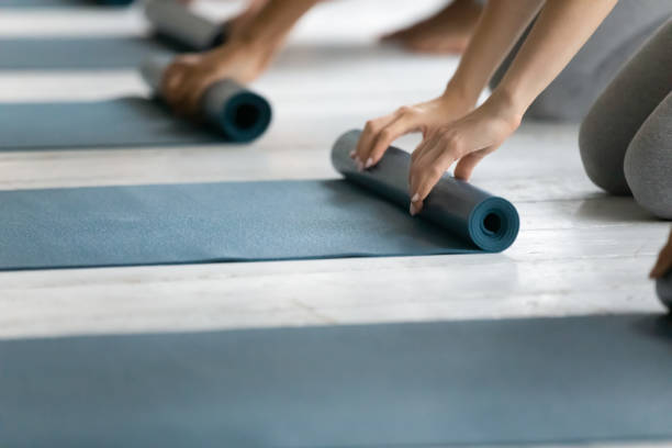 istock People folding yoga mat after working out in studio 1198296953