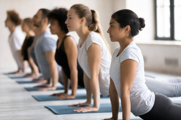 istock Diverse people doing upward facing dog exercise, practicing yoga 1198296956
