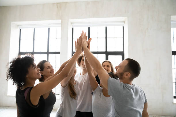 istock Happy smiling diverse people sharing success, giving high five 1198296979