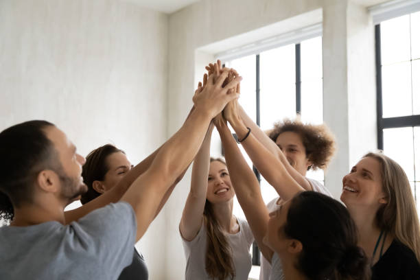 istock Successful team diverse people giving high five, sharing success 1198296981