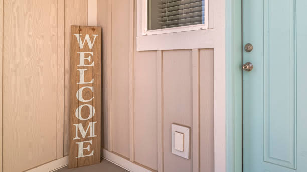 istock Panorama frame Green wooden front door with welcome sign 1198297873