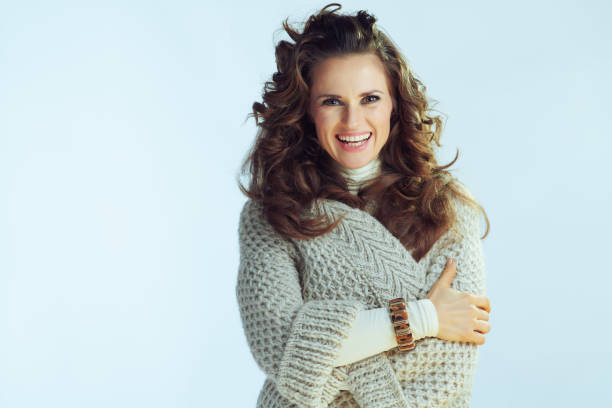 istock smiling stylish female against winter light blue background 1198297941
