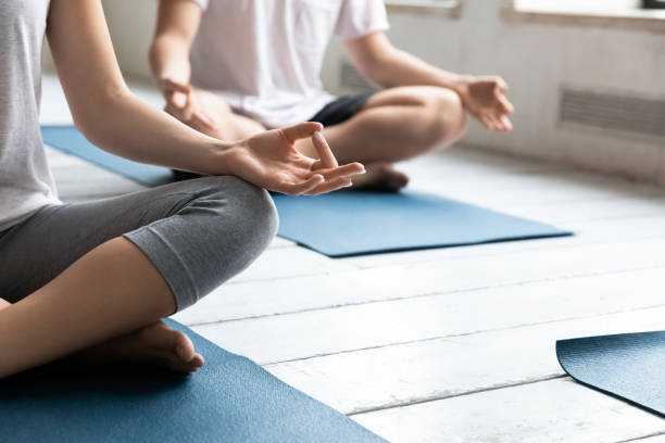 istock Sporty people practicing yoga at group lesson, doing Sukhasana exercise 1198298353