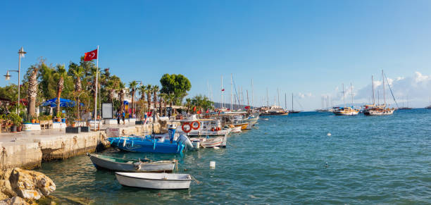 Mugla, Turkey - 24 May 2019 : View of Bodrum Marina, Aegean sea, traditional white houses, flowers, marina, sailing boats, yachts in Bodrum city town Turkey.