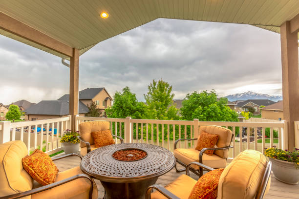 istock Balcony with chairs around table with fire pit against homes and mountain view 1198301258