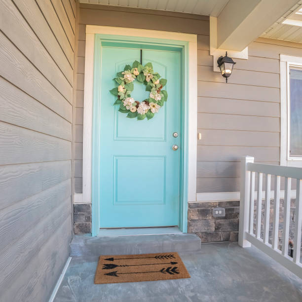 istock Square frame Wooden blue front door with wreath on a sunny day 1198303459