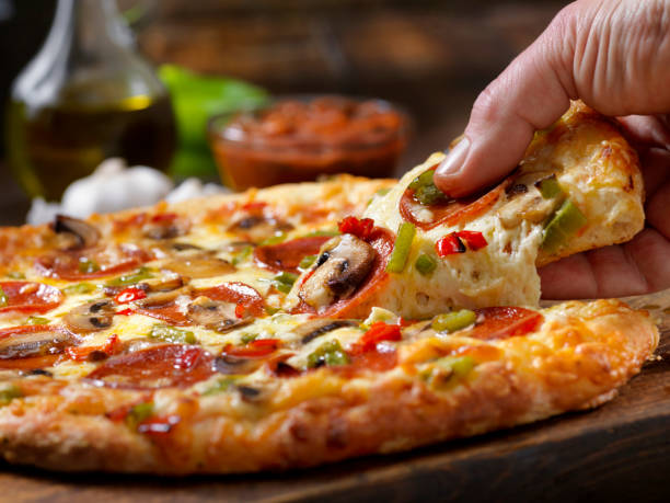 istock Taking the First Piece of Pizza 1198304428