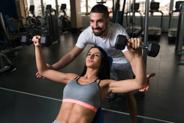 istock Couple With Dumbbells Exercising Back In Gym 1198306430