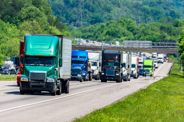 istock Green 18-Wheeler Leads Heavy Highway Traffic 1198307005