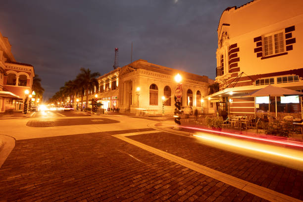 Photo of an urban scene in downtown Sarasota, Florida, USA with street lights and trees decorated with Christmas lights at twilight blue hour.
