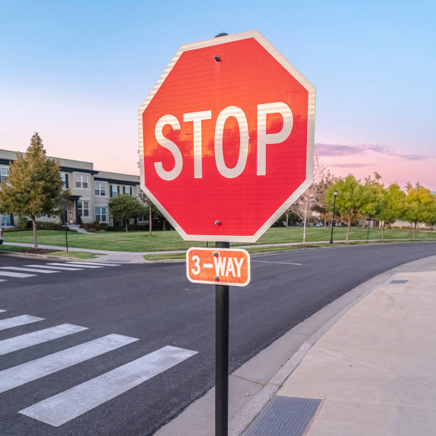 istock Square 3-Way Stop at a street intersection at sunset 1198307216