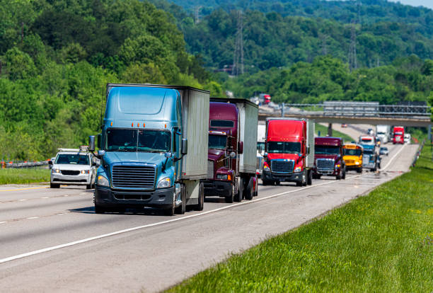istock Blue Semi climbs Interstate Hill In Heavy Traffic 1198307293
