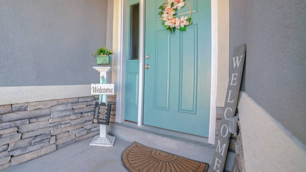 istock Panorama frame Welcome signs alongside a green front door 1198308101