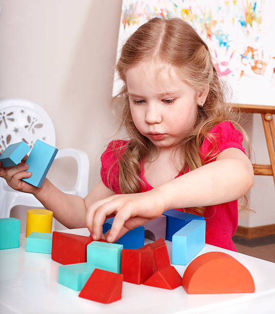 istock Child preschooler play wood blocks. 119830846