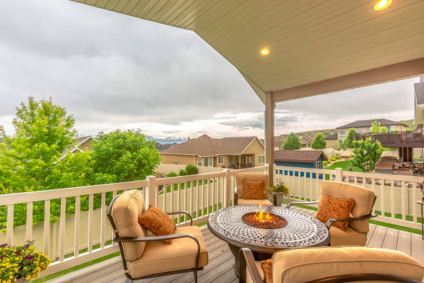 istock Chairs around table with fire pit at a residential balcony framed with railings 1198310857