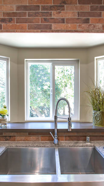 istock Vertical frame Kitchen sink close up with bay windows in the background 1198311008