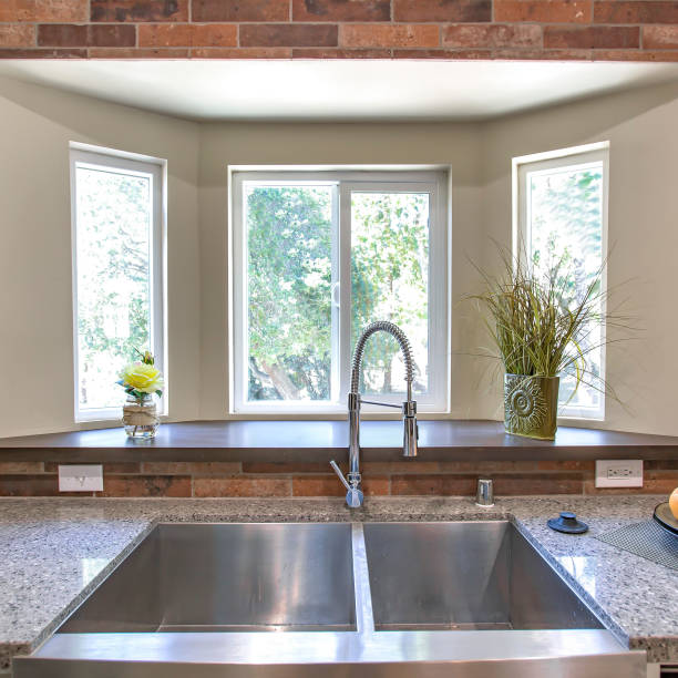 istock Square Kitchen sink close up with bay windows in the background 1198311011