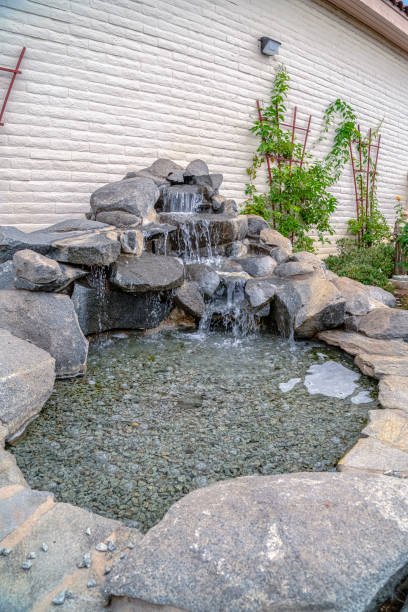 istock Outdoor stone decoration with cascade waterfall on a sunny day 1198312763