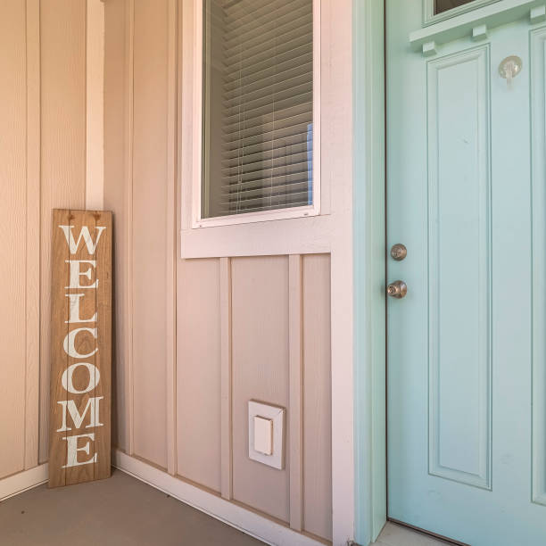 istock Square Green wooden front door with welcome sign 1198312965
