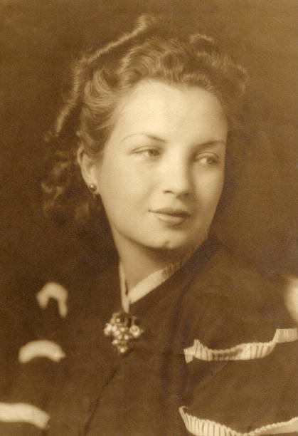 старое изображение (сделано в 1935 году) студийный снимок кавказской молодой женщины, смотря в сторону - 1930 стоковые фото и изображения