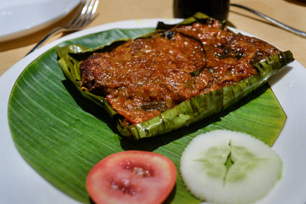 Kerala traditional fish curry coconut on banana leaf