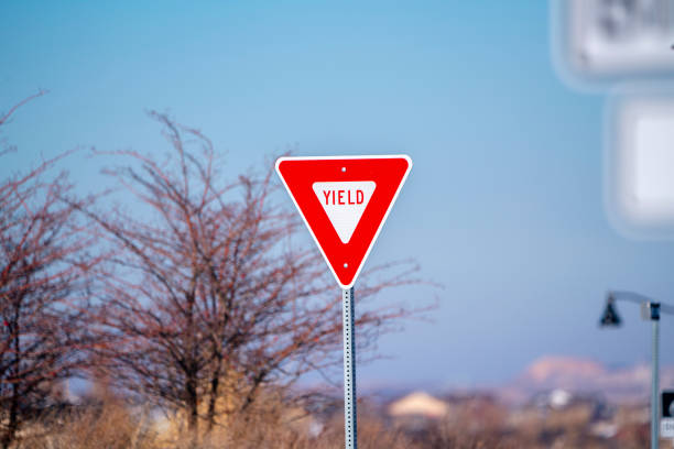 istock Red traffic Yield sign alongside a road 1198314264