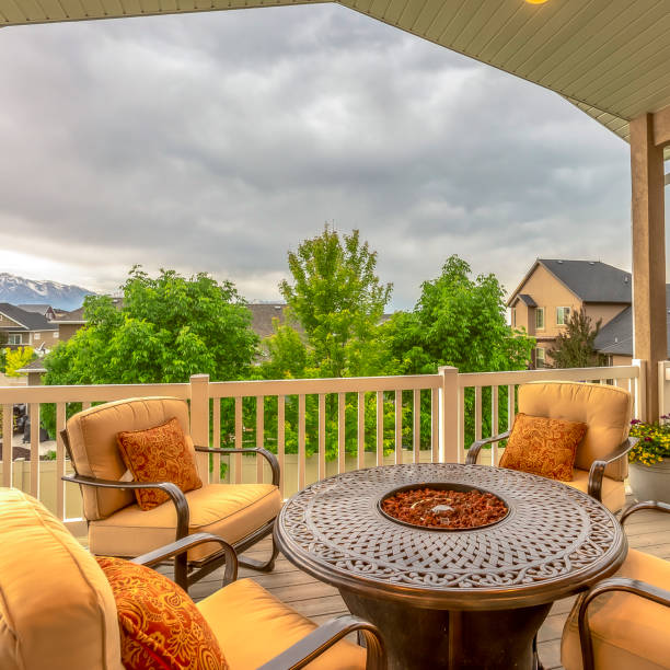 istock Square Balcony with chairs around table with fire pit against homes and mountain view 1198315475