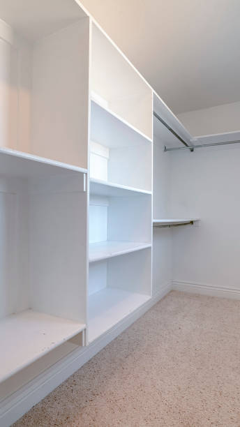 istock Vertical frame Empty white fitted interior of walk-in wardrobe 1198318911