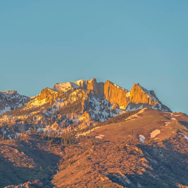 istock Square frame Striking mountain peak with rugged slopes against blue sky on a sunny day 1198319802