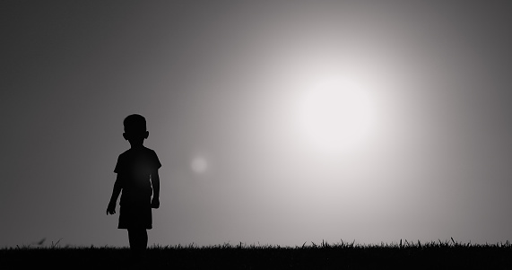 Little child walking in a field.