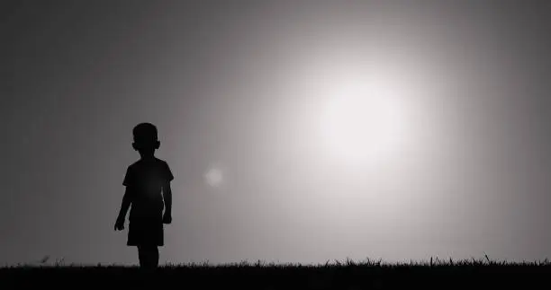 Little child walking in a field.