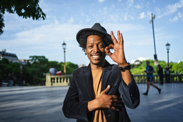 istock Well dressed young man holding an ok hand sign 1198320786
