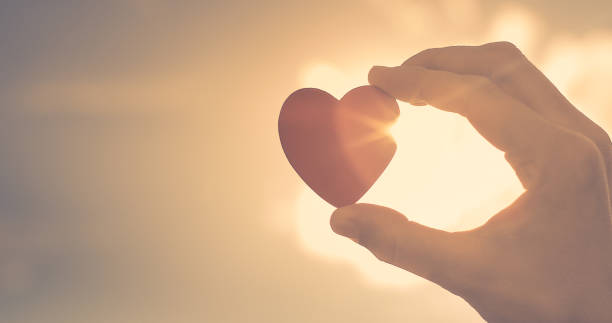 istock Hand holding heart at sunset 1198320950