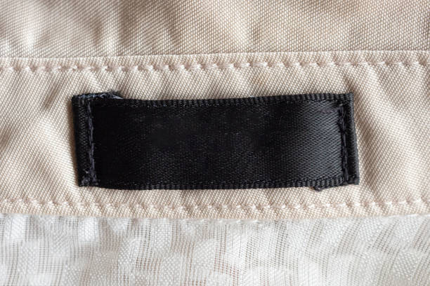 istock Blank black laundry care clothing label on fabric texture 1198321925