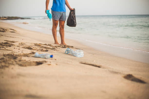 istock Valunteer man cleaning the beach 1198322137