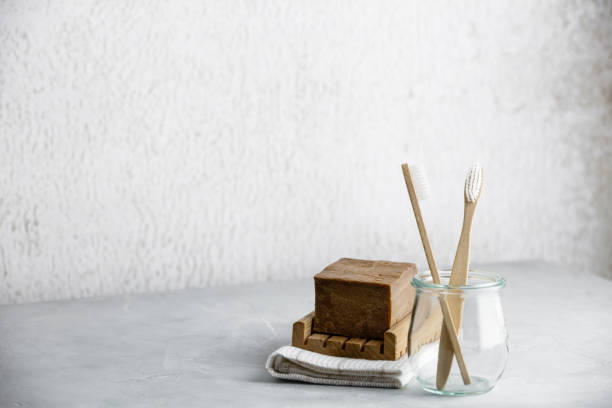 istock Eco-friendly bamboo toothbrushes in a glass jar and handmade organic soap, copy space 1198326856