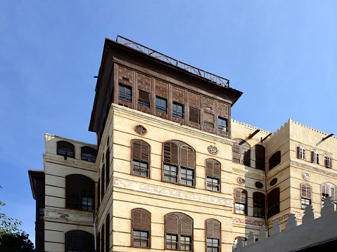Jeddah, Mecca Region, Saudi Arabia: Nassif House / Beyt Nassif - hedjazi architecture with Turkish influence, Al Balad district, corner of al-Alawi and on Bahrhat Ashur Streets - building with Arabian closed wooden balconies (rawasheen / mashrabiyas). Built between 1872 and 1881 by Sheikh Umar Effendi al-Nassif. Constructed of limestone bearing walls reinforced with wooden beams. The façade is covered with limestone plaster. Historic Jeddah, the Gate to Makkah, UNESCO world heritage site. Red Sea coastal coral building tradition.