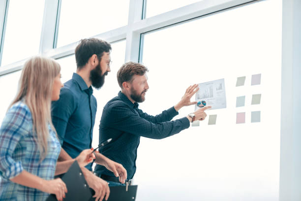 istock successful boss is discussing with the staff of financial performance 1198328056