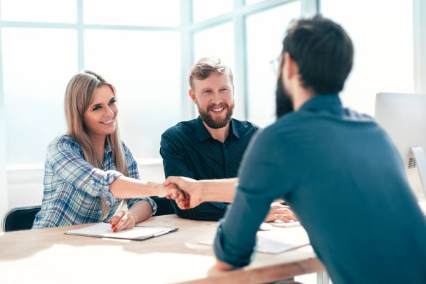 istock managers interview the applicant sitting at the office table. 1198328058