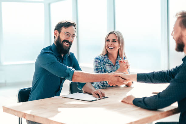 istock smiling young man answering employers ' questions during the interview 1198328061