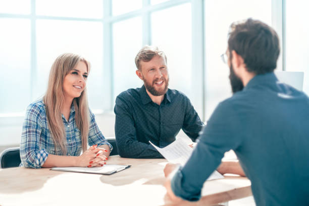 istock managers interview the applicant sitting at the office table. 1198328078