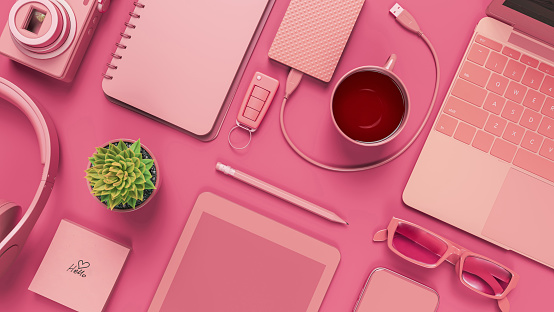 Mesa de escritorio rosa con cuaderno en blanco. photo