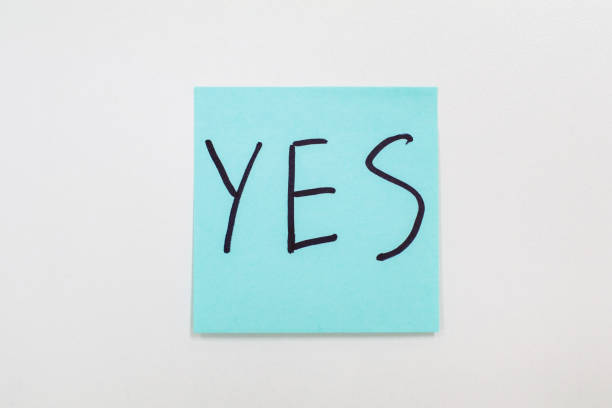 istock Writing on colorful sticky note Blue sticky note isolated on a white background with the word Yes Agreement and compliance concept 1198333136