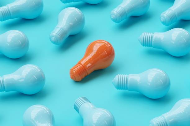 istock Orange Light bulb Among blue Light bulbs on blue background.  Ideas Concept. 3D Render. 1198334356