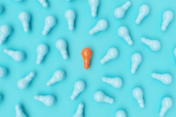 istock Orange Light bulb Among blue Light bulbs on blue background. Top view. Ideas Concept. 3D Render. 1198334359